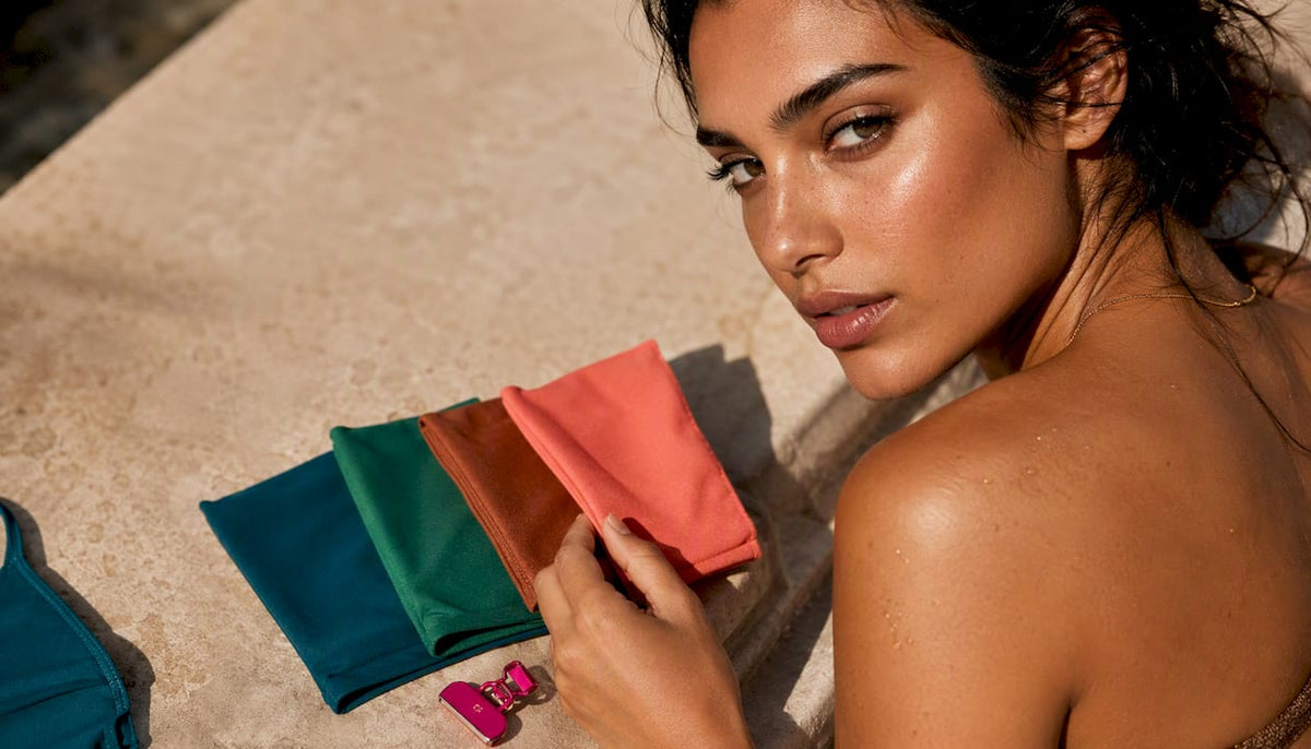 Olive skin beside jewel tone fabric swatches
