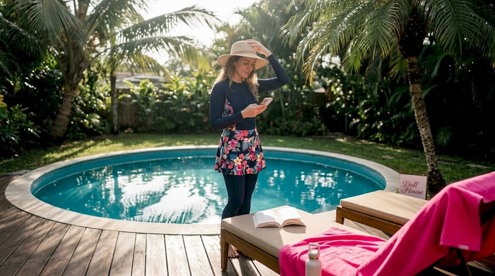 Woman in modest swimwear adjusting sun hat by pool