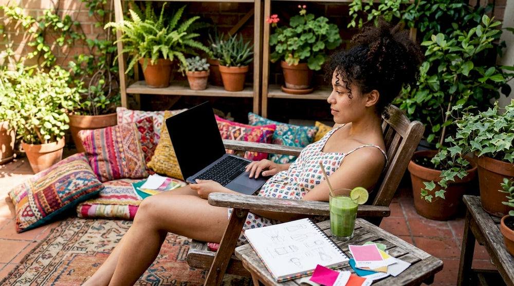Woman browsing swimwear collections online at home