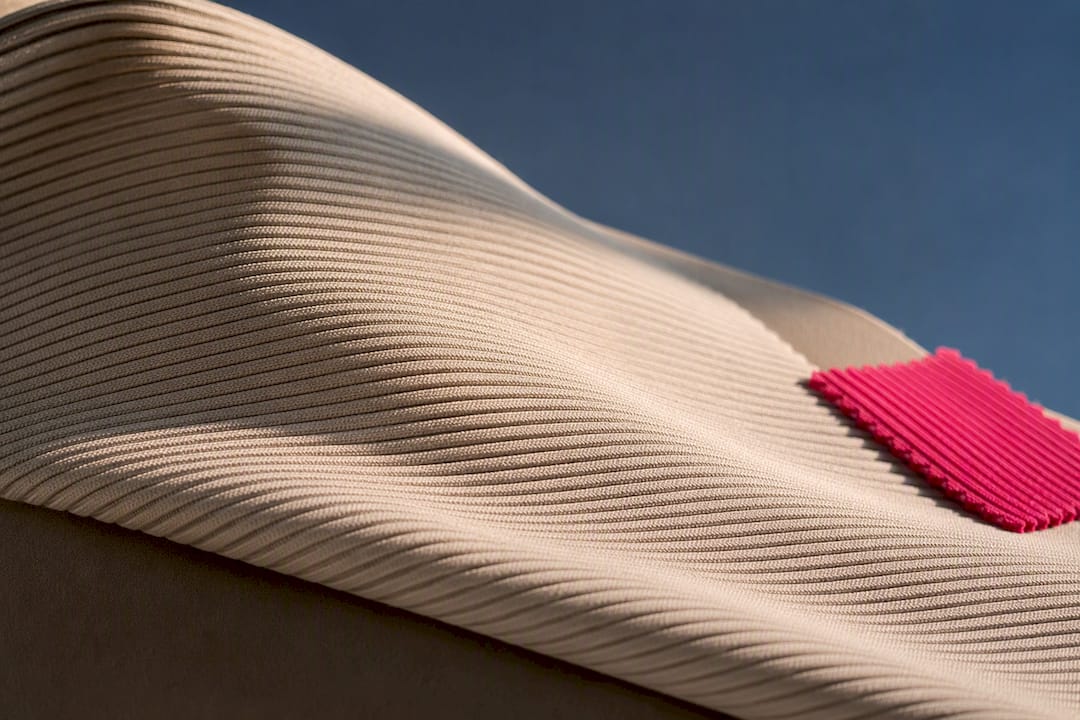 Ribbed swimwear fabric catching dramatic light