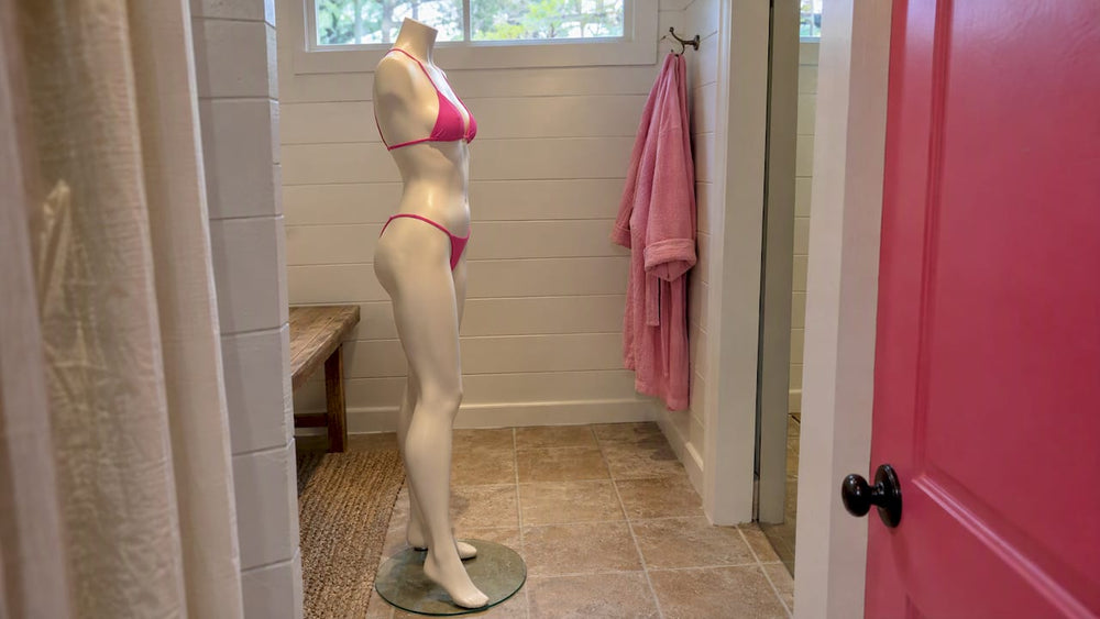 Woman checking the fit of a minimal swimsuit