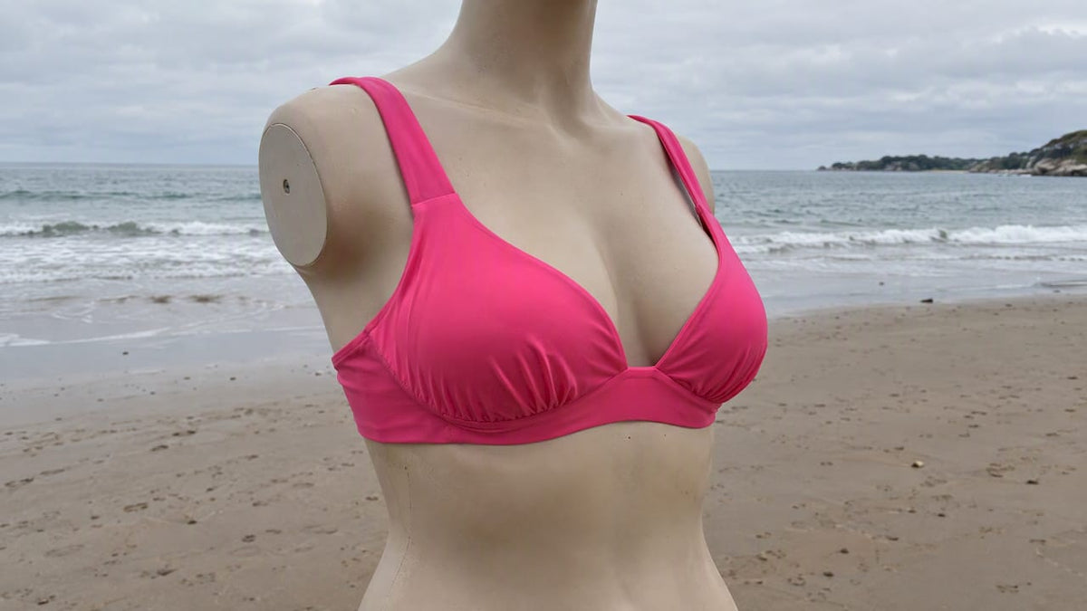 Woman wearing a supportive pink wireless bikini top
